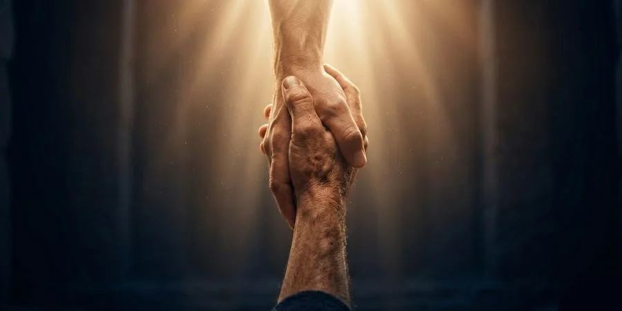 Two hands reaching toward each other in warm golden light, representing Christ's calling in Bible verses about failure