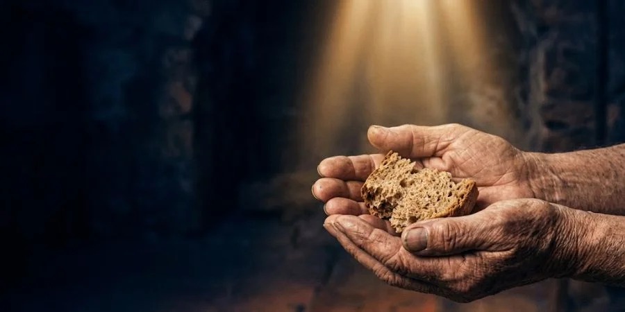 Weathered hands cupped upward in golden light representing Bible verses about discrimination against the poor and God's equal love