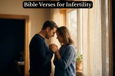 A husband and wife praying together in golden window light, representing Bible verses for infertility and shared hope.
