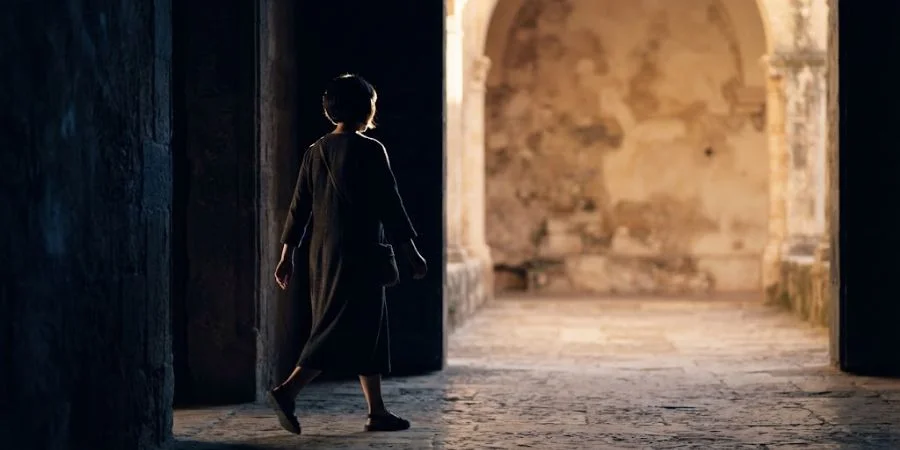 A figure stepping from shadow into light, symbolizing Bible verses about evil doers and new identity in Christ.