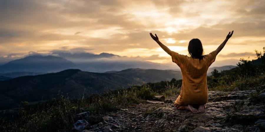 A figure kneels with open hands raised to the sky, symbolizing Bible verses about fake friends and surrender.