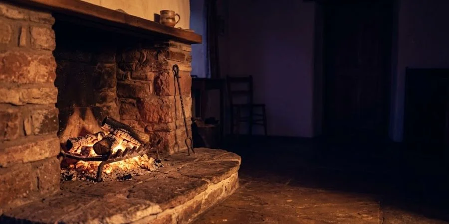 A hearth fire fading to embers, symbolizing Bible verses about arguing and quarrels that die without fuel