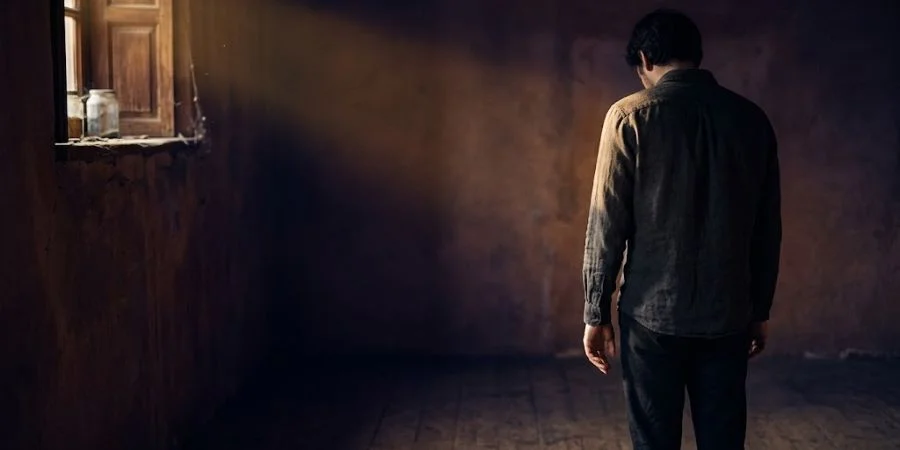 A figure pausing with an unclenching hand in golden light, symbolizing Bible verses about arguing and restraint