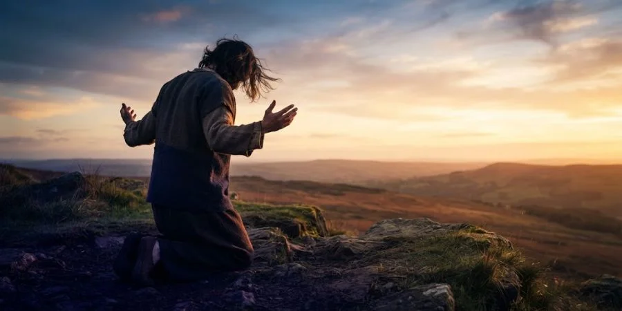 Figure rising from a bowed posture into open light, representing Bible verses about resilience turning suffering to hope.